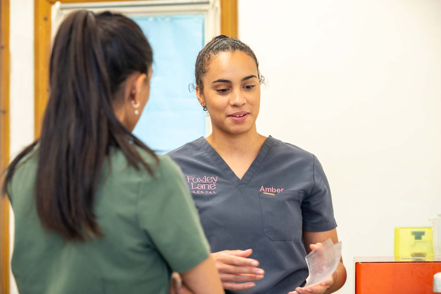 Dental nurse Amber Payne chatting with a colleague