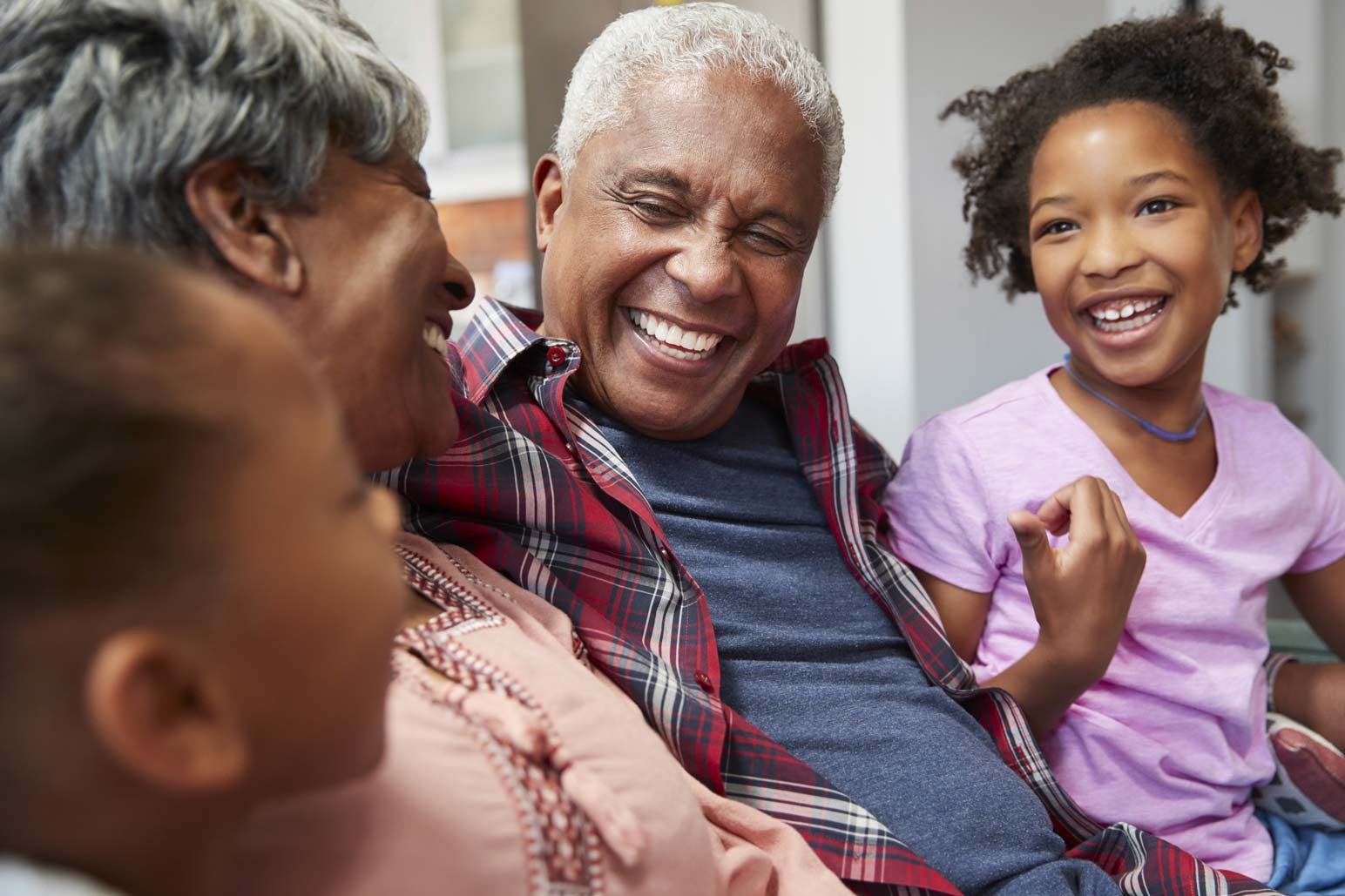 Smiling family enjoying time together, representing confidence after replacing missing teeth in Purley
