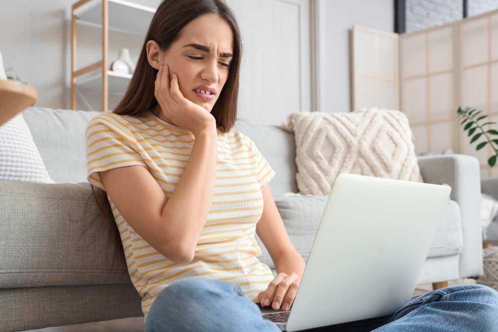 Woman experiencing toothache that may require root canal treatment