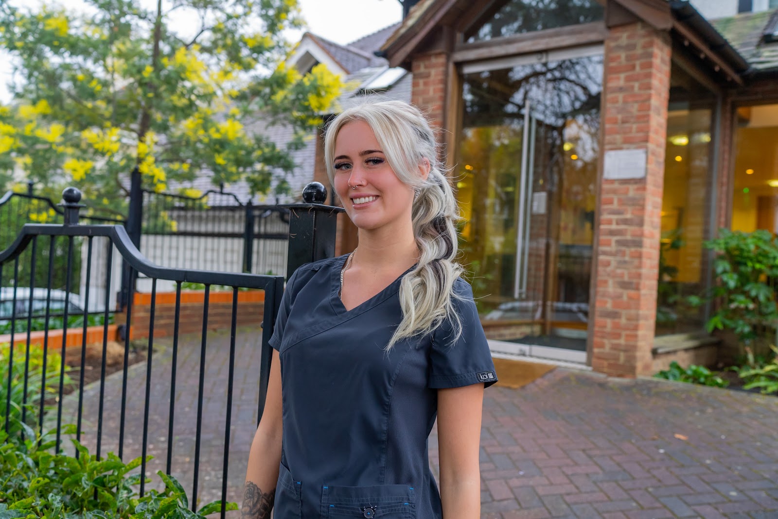 Friendly dental professional outside Foxley Lane Dental in Purley, offering Invisalign treatment