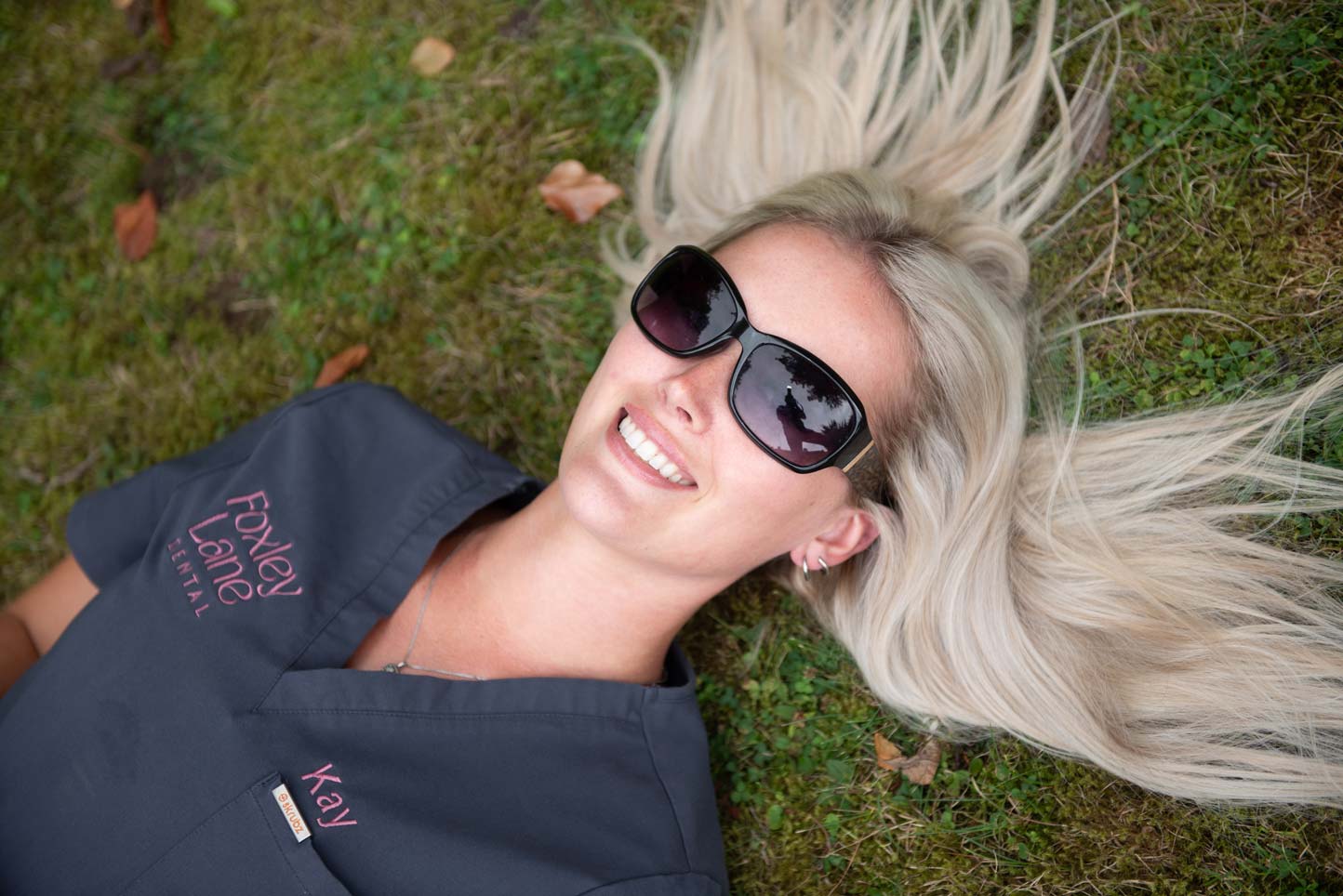 Dental nurse Kayleigh Woolacott relaxing outdoors in the practice garden.