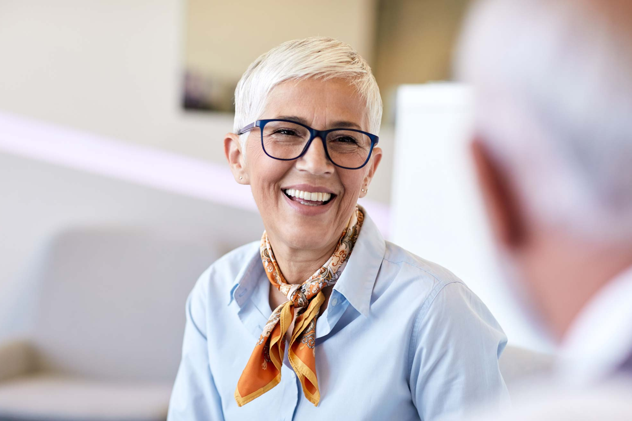 Smiling patient after restorative dental treatment and full mouth dental implant consultation