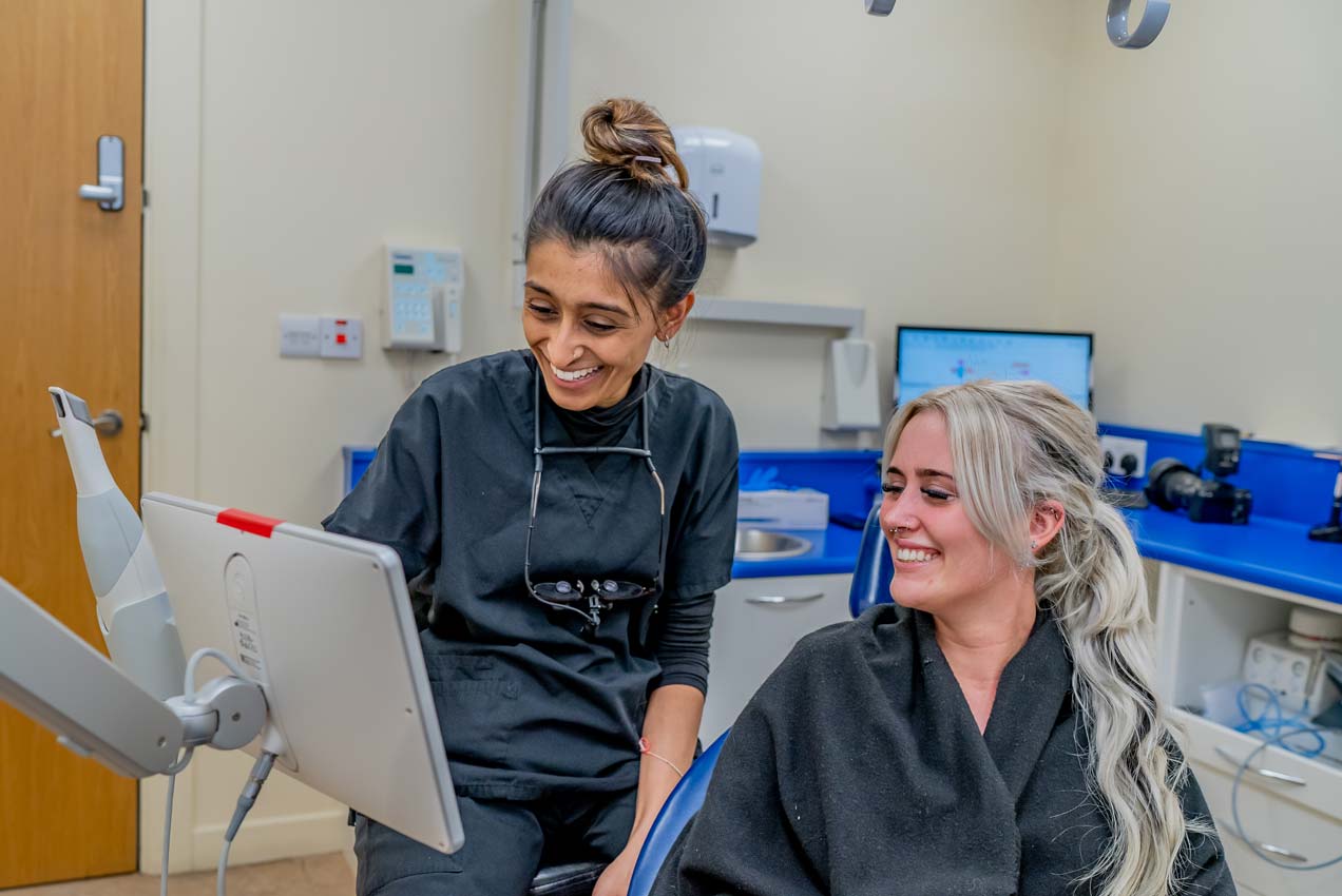 A cosmetic dentist discussing plans with a patient.