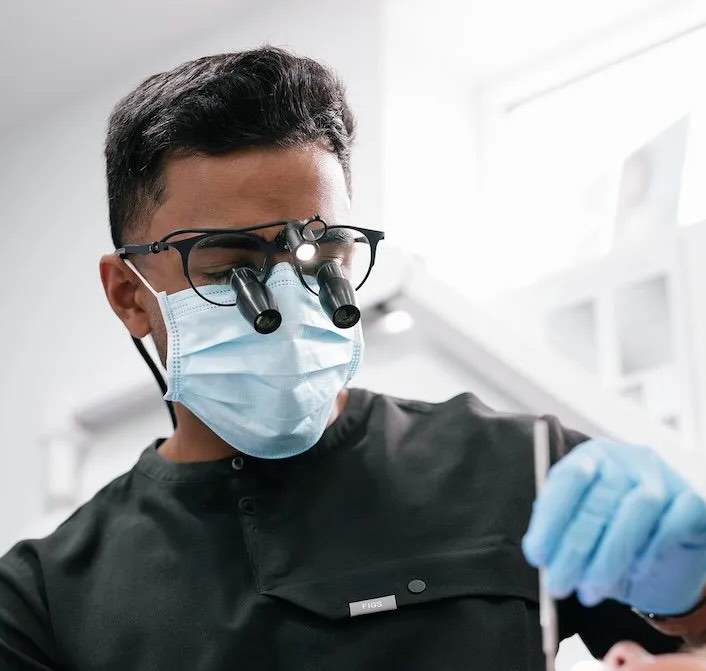Dr Nev Jeyakumar carrying out advanced dental implant treatment near Caterham