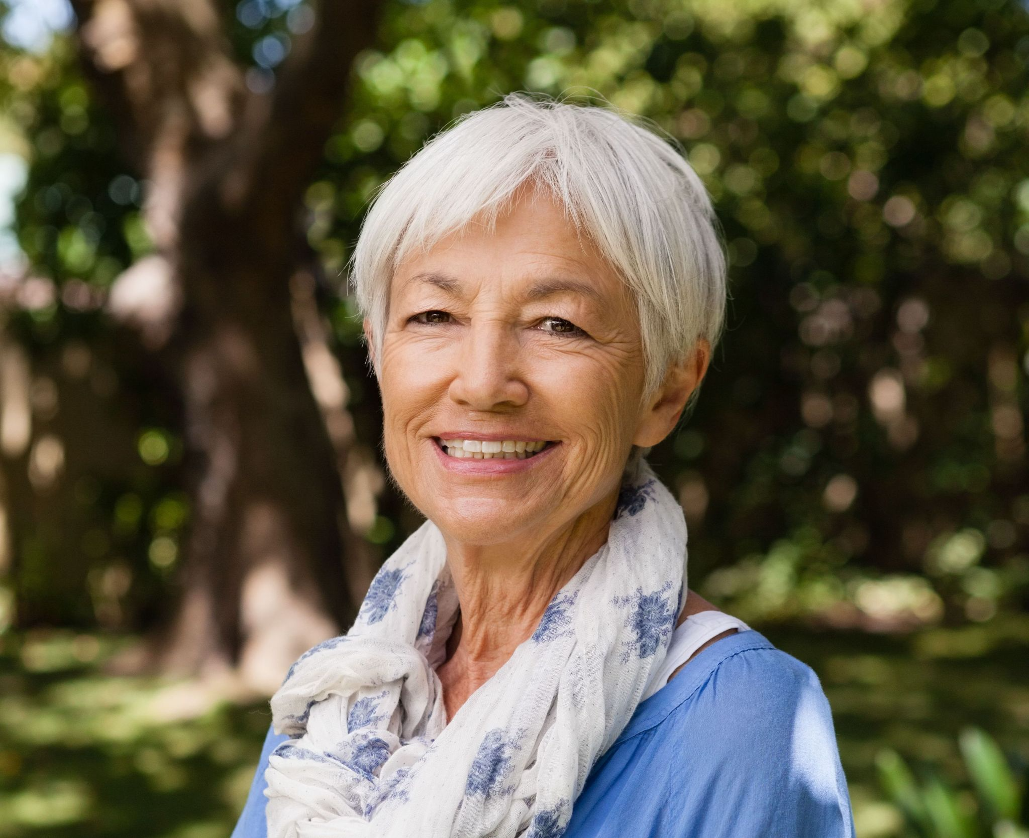 Confident woman enjoying life after complete dental implants, also called complete mouth dental implants or whole mouth implants, at Foxley Lane Dental Purley