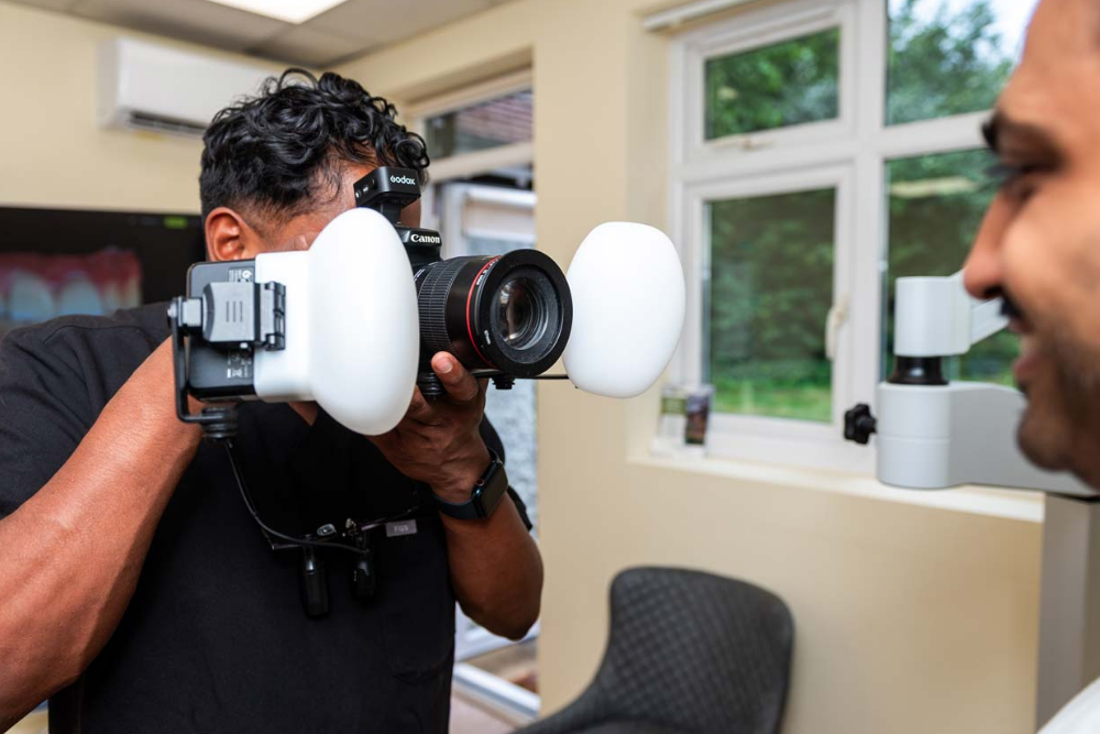 Dentist Dr Jamie Sasikumar taking digital photographs for Invisalign treatment planning