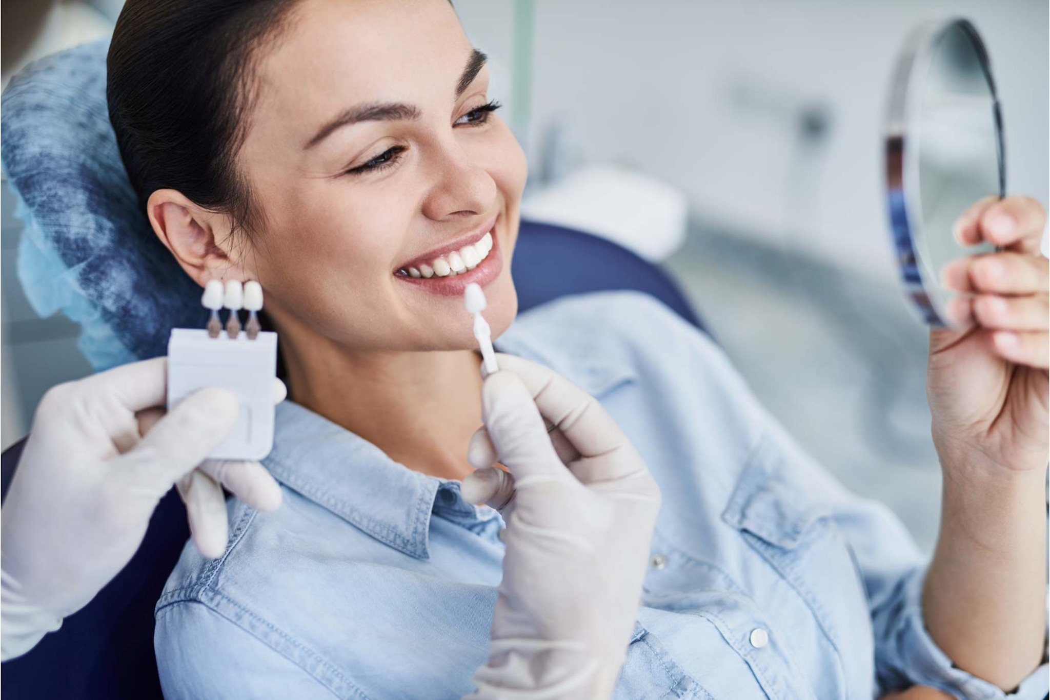 Patient comparing tooth shades during professional cosmetic teeth whitening consultation in Purley