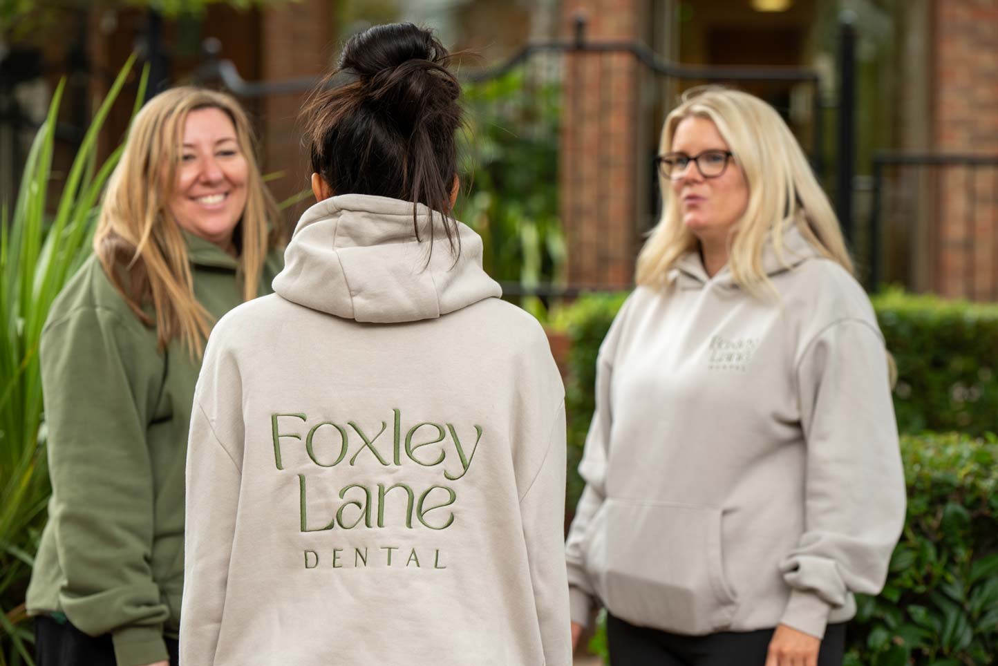 Team members Punita, Kayleigh and Laura chatting outside the Foxley Lane Dental building