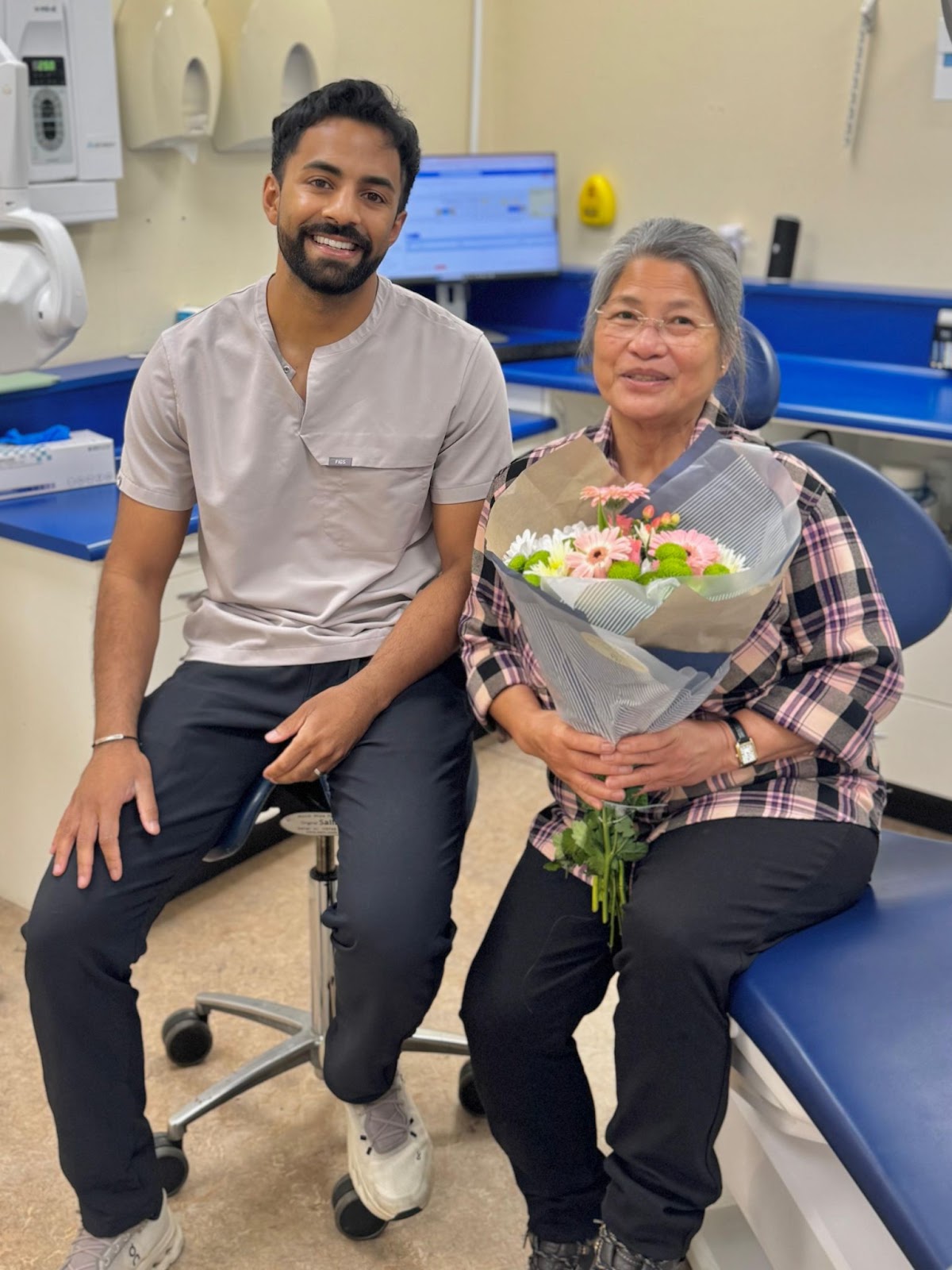 Foxley Lane Dental implant dentist with a smiling patient holding flowers after treatment, highlighting positive recovery and care.