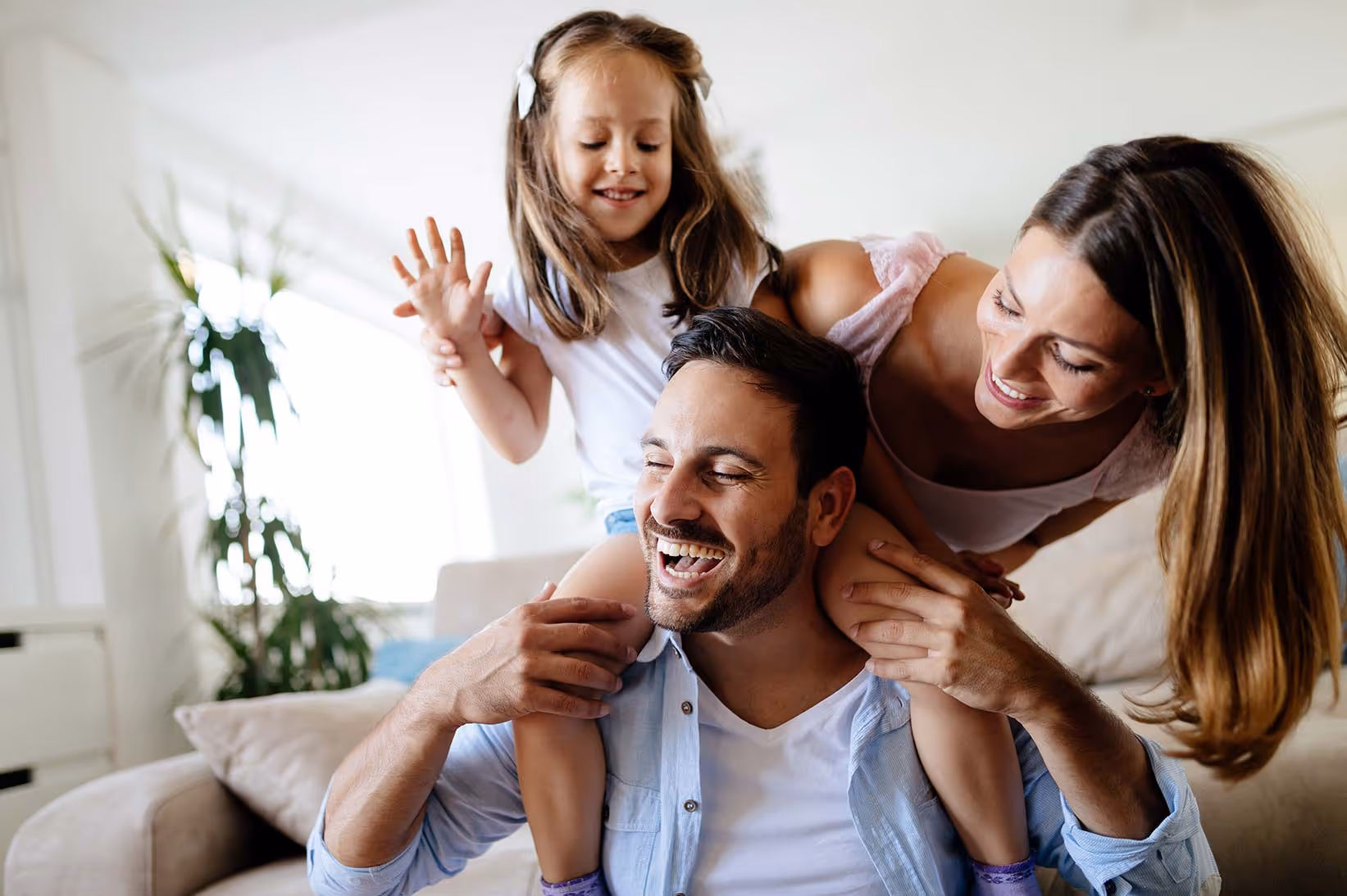 Happy family smiling together, reflecting trusted care from a family dentist near me in the Purley, Croydon area