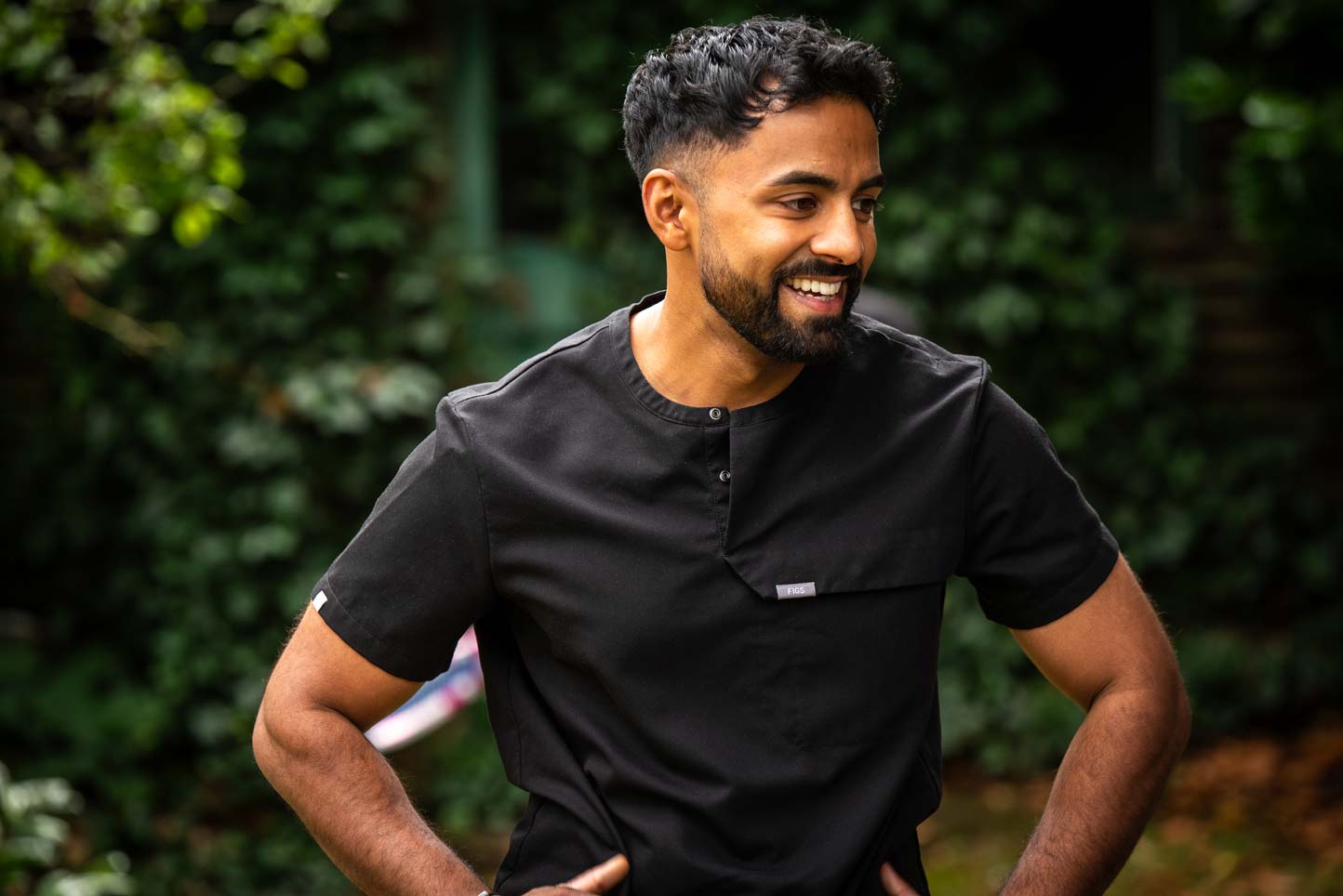 Dr Nev Jeyakumar, specialist in dental implantology, welcoming patients outside our Purley clinic.