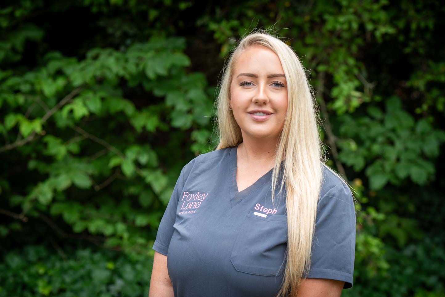 Dental nurse Stephanie Evans standing outdoors, representing ongoing preventive dental care.