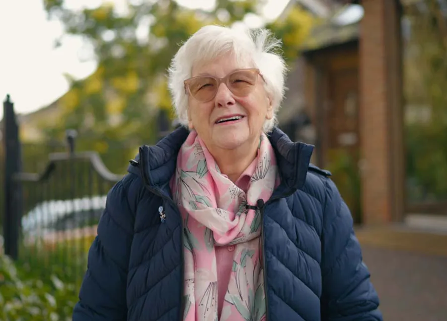 Patient Barbara smiling outdoors after her dental care visit