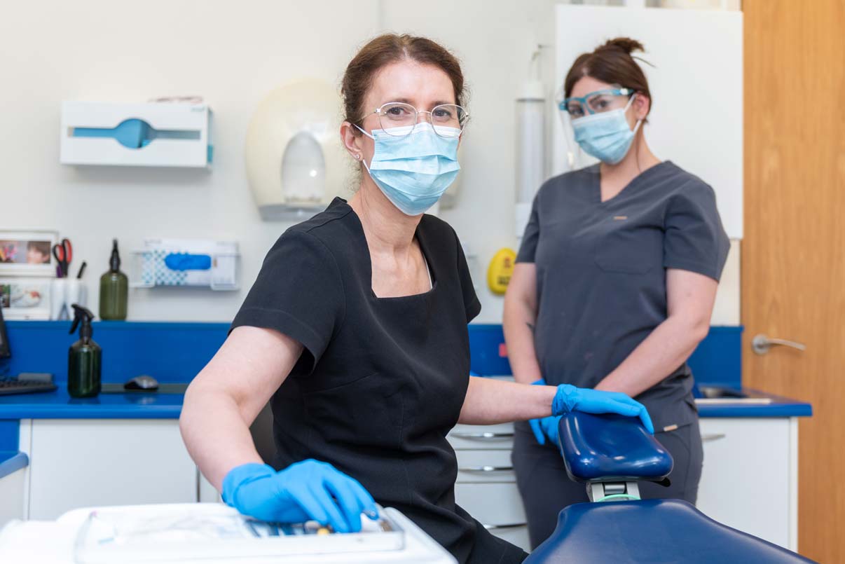 Dental team Dr Christine Marzahn and Natalia Morena preparing a treatment room for an emergency dental appointment.